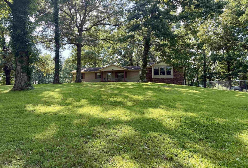 Expansive green lawn with mature trees