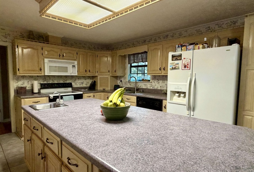 Kitchen featuring an expansive center island with an integrated sink