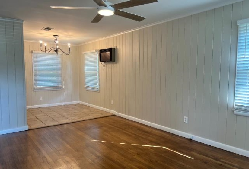 Living room featuring wood-finish flooring and vertical paneling