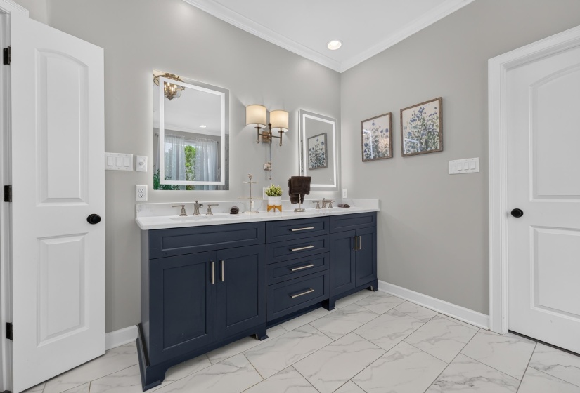 Dual vanity with deep blue cabinetry, white countertop, and integrated sinks