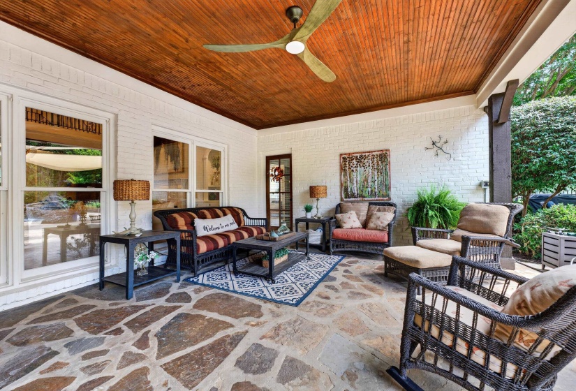 Covered patio featuring a natural stone flagstone floor and a wood-paneled ceiling