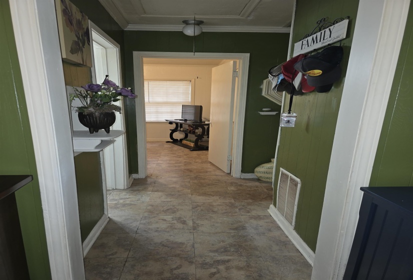 Hallway featuring paneling walls and tile flooring