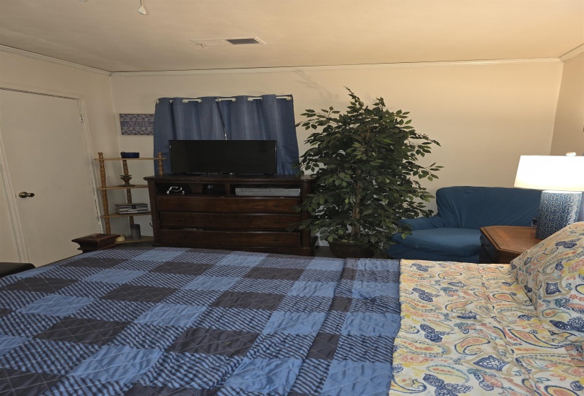 Warm, neutral wall tones complement dark wood-finish flooring