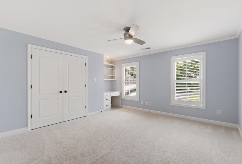 Spacious room featuring light-colored carpeting and soft blue walls