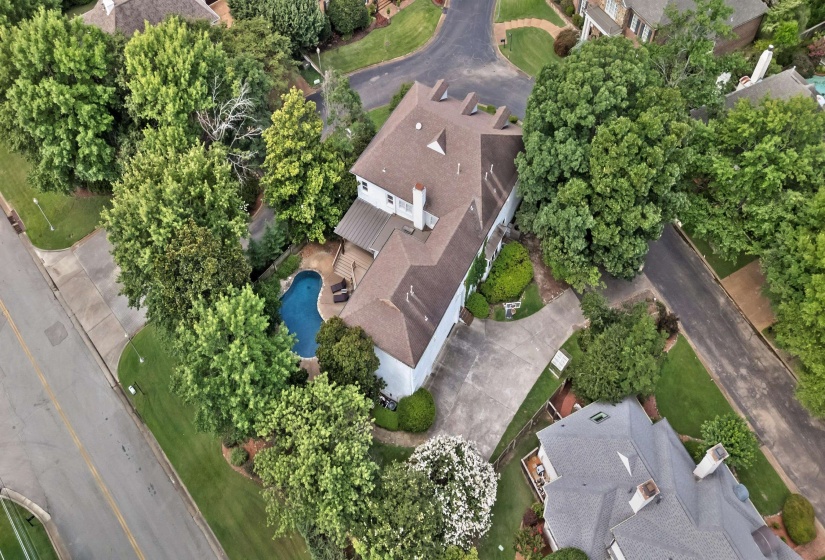 Two-story residence featuring a brown shingle roof and white siding