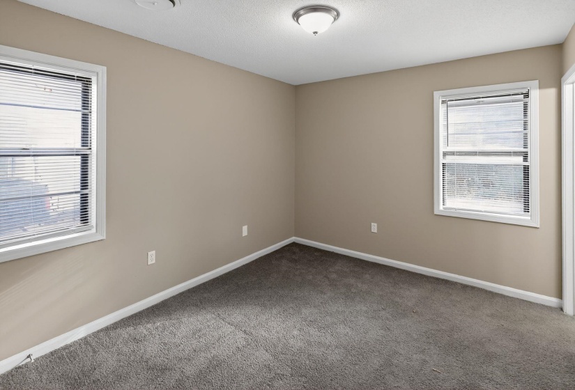 Unfurnished room featuring carpet floors and a textured ceiling