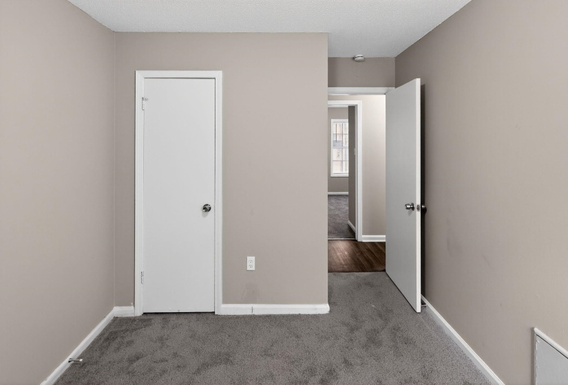 Unfurnished bedroom featuring carpet flooring and a textured ceiling