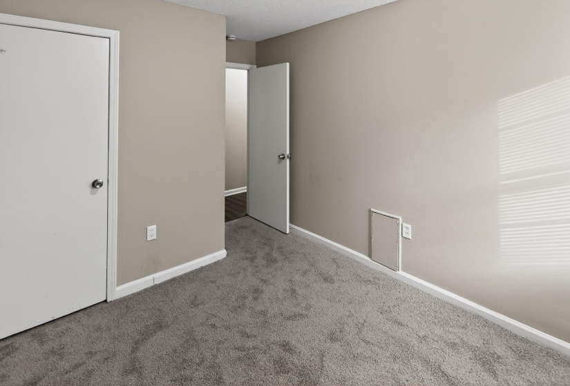 Unfurnished bedroom with carpet and a textured ceiling