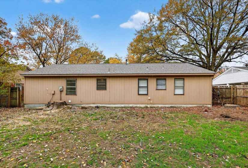 View of side of property with a shingled roof