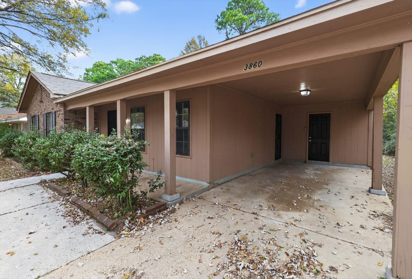 View of patio / terrace featuring a carport and concrete driveway