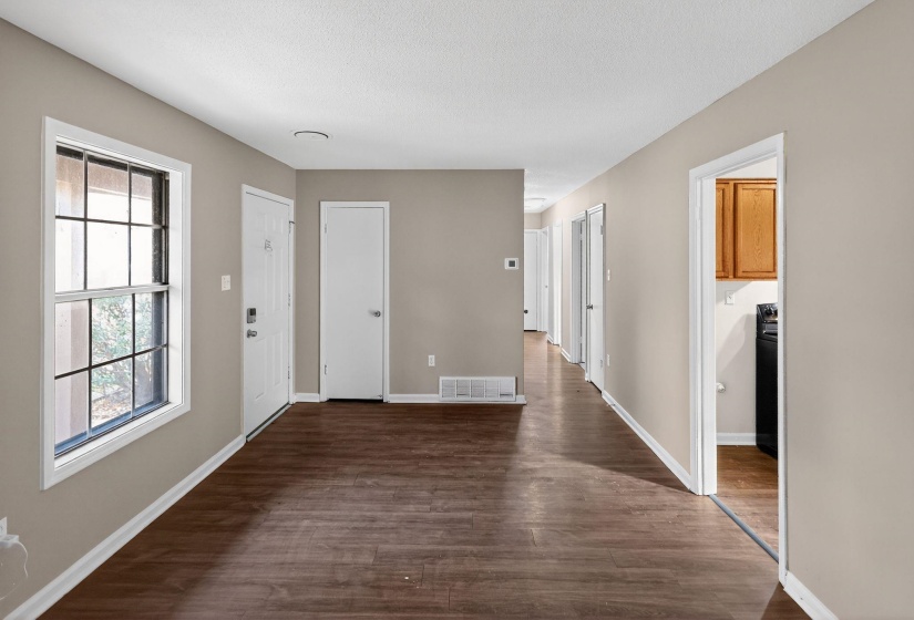 Entrance foyer featuring dark wood finished floors and a textured ceiling