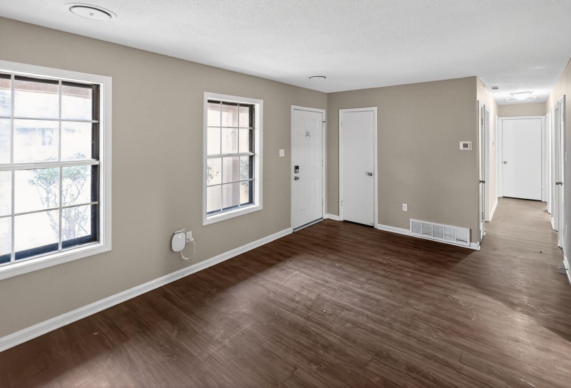 Entrance foyer with dark wood finished floors and a textured ceiling