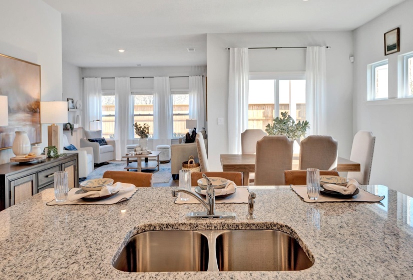 Kitchen with light stone countertops and open floor plan