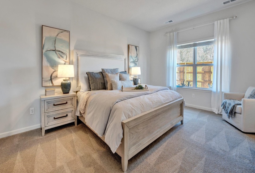 Bedroom featuring light carpet and baseboards
