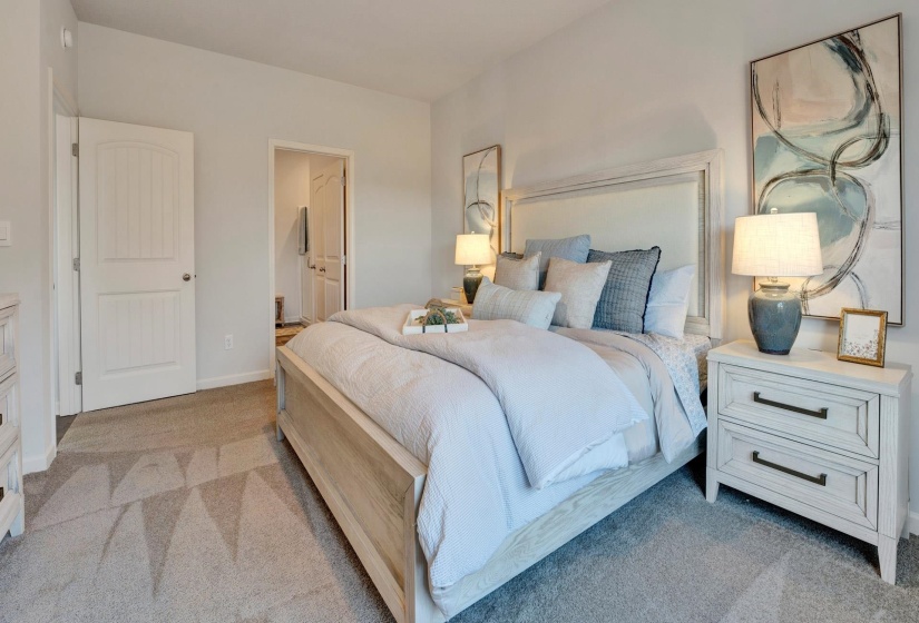 Bedroom with light carpet and ensuite bathroom