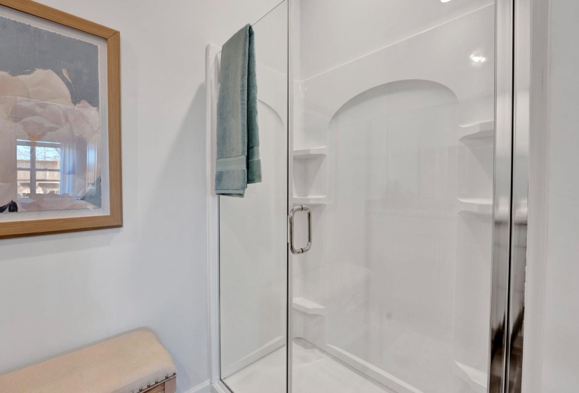 Full bathroom featuring a stall shower and ensuite bathroom