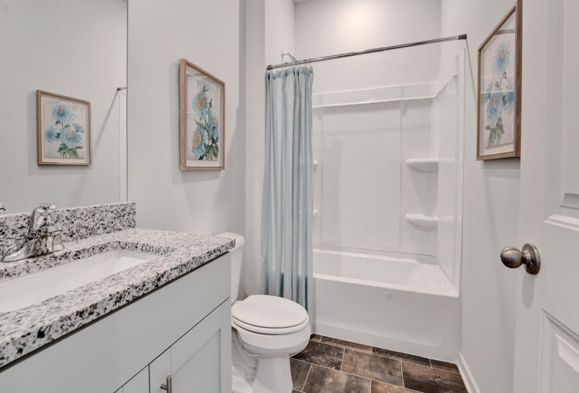 Full bath with shower / bath combination with curtain and vanity