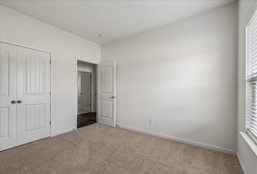 Neutral wall paint with textured carpet flooring