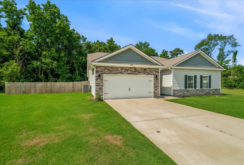 Ranch-style exterior featuring a stone facade, horizontal siding, and textured shingle accents