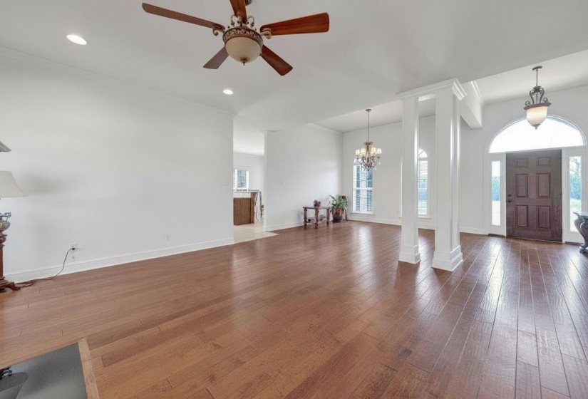 Open concept living area featuring wood-finish flooring throughout