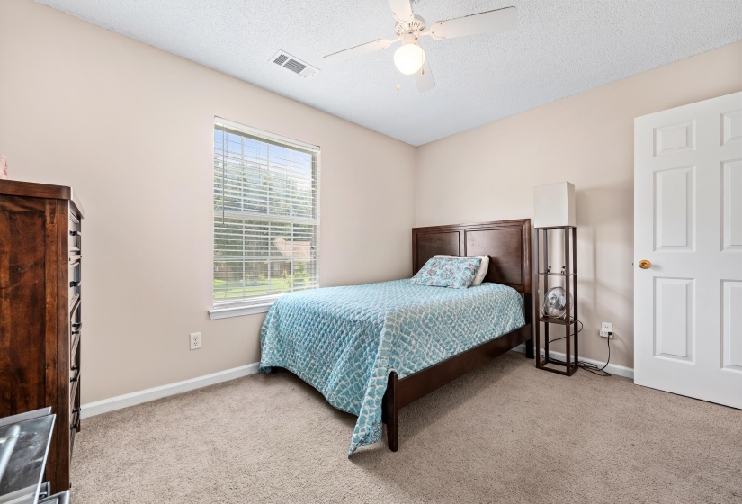Room featuring a single window with blinds, neutral wall paint, and light-colored carpeting