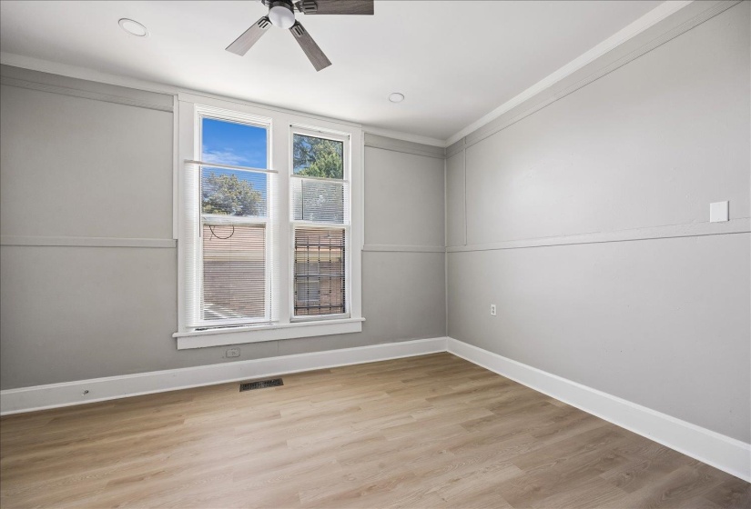 Room featuring two windows, wood-finish flooring, ceiling fan, and recessed lighting