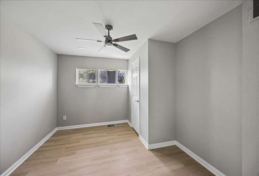 Neutral gray wall paint complementing wood-finish flooring