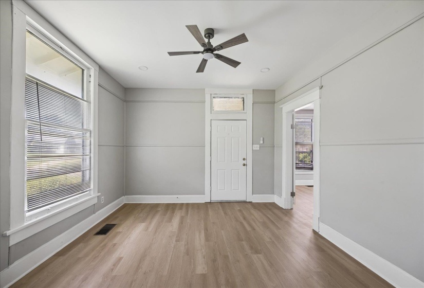 Spacious room featuring light wood-finish flooring, recessed lighting, and a ceiling fan