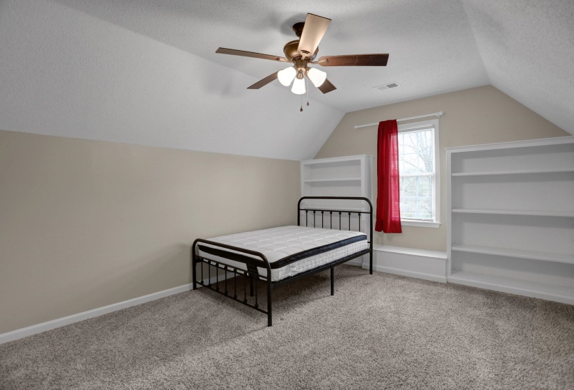 Bedroom featuring light colored carpet, ceiling fan, and a textured ceiling