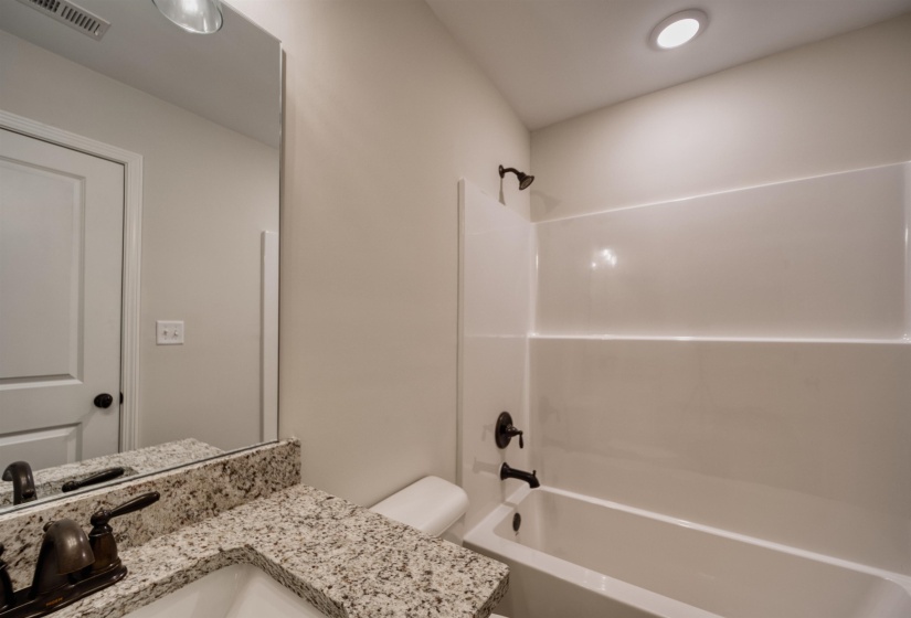 Bathroom featuring  shower combination and vanity