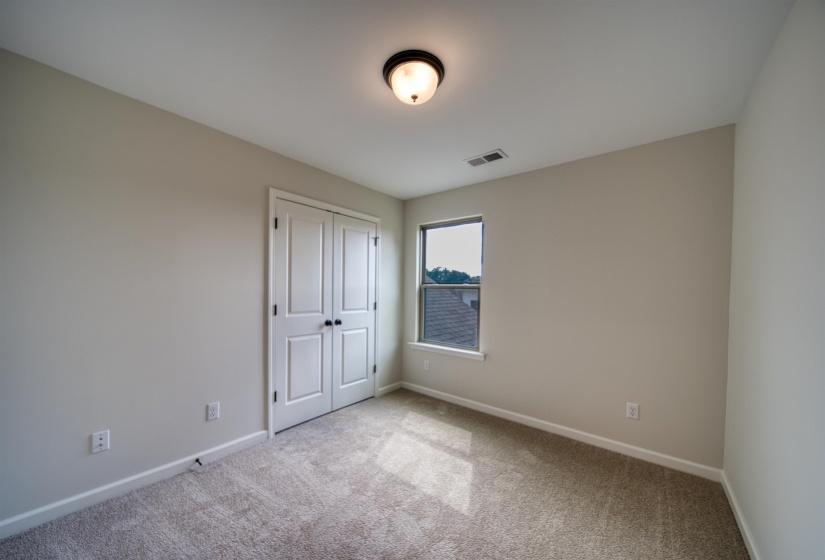 Unfurnished bedroom featuring carpet flooring and a closet