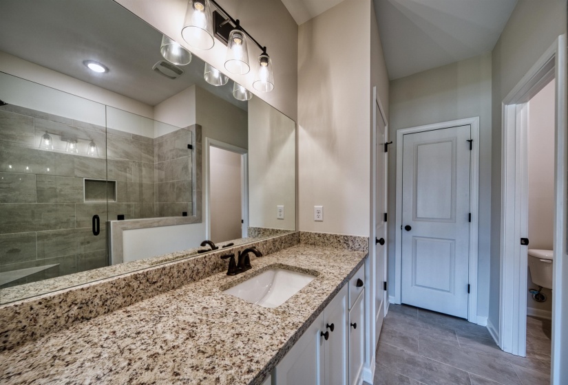 Bathroom featuring a stall shower and vanity