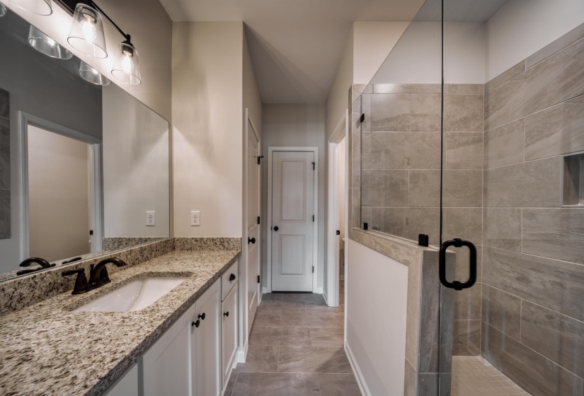Full bath with vanity and a shower stall