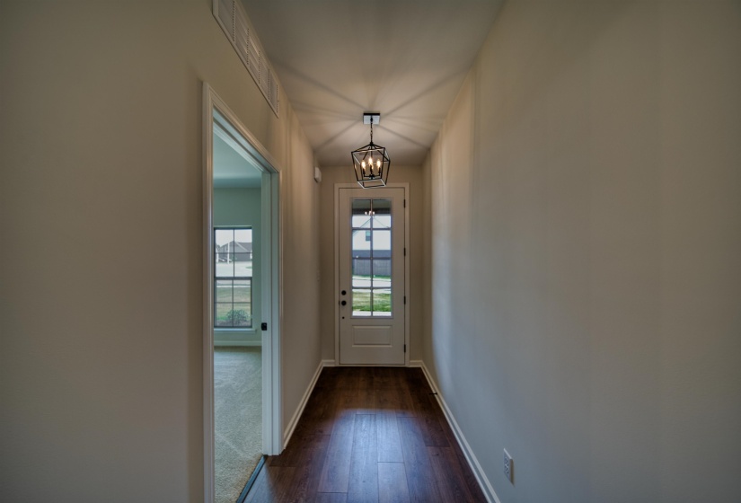 Entryway featuring a chandelier and hardwood / wood-style flooring