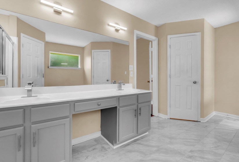 Dual vanity with gray cabinetry, white countertops, and modern chrome fixtures