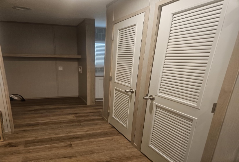 Two louvered closet doors with brushed nickel hardware