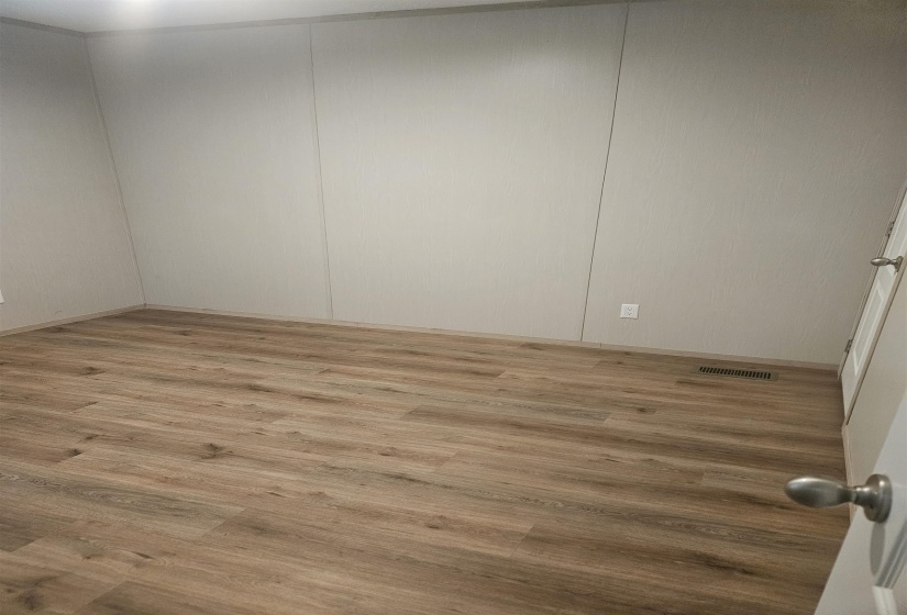 Light wood-finish flooring with a neutral wall color