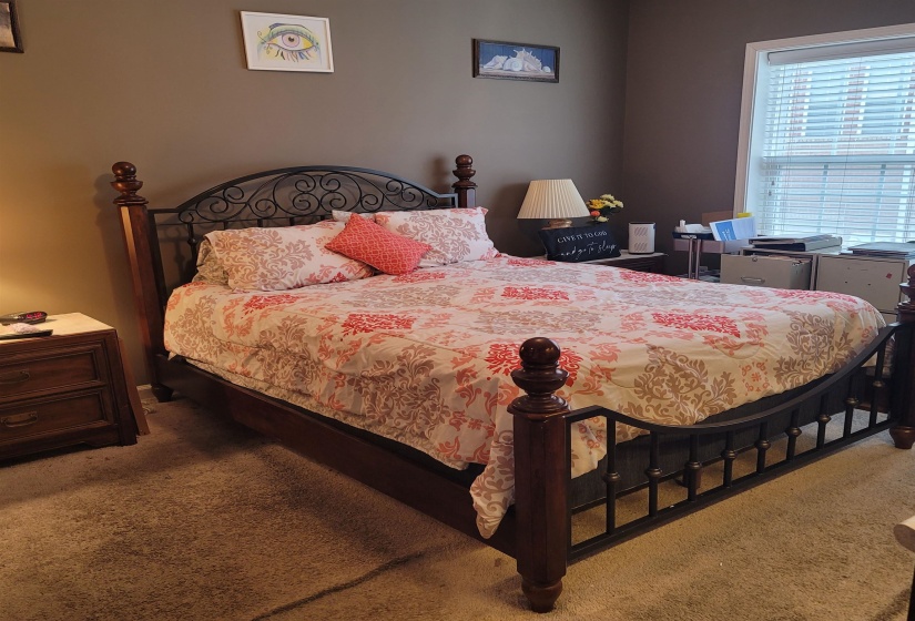 Carpeted room with a single window featuring horizontal blinds