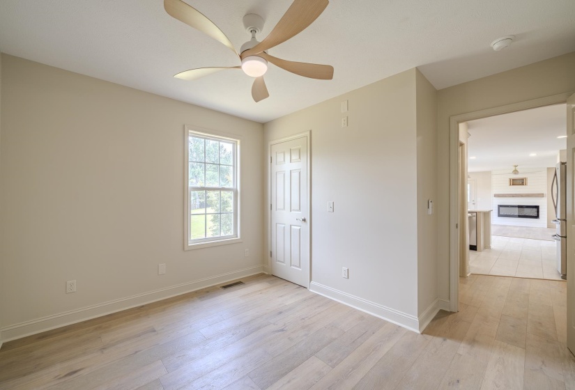 Light wood-finish flooring complements the neutral wall tones