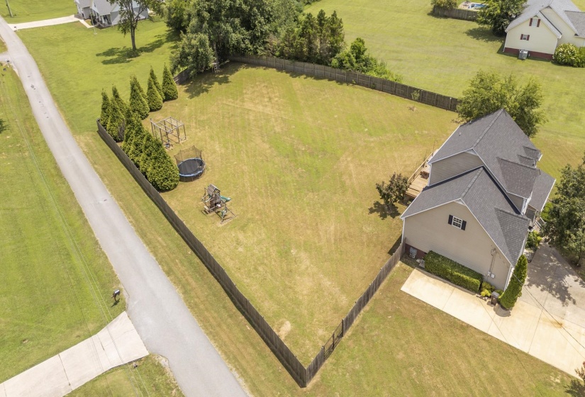 Spacious property featuring a large, fenced backyard with mature trees and ample green space