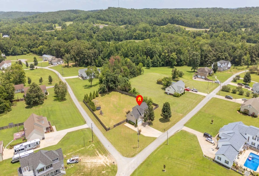 Expansive property featuring a single-family home with a detached garage, a fenced rear yard, and a paved driveway