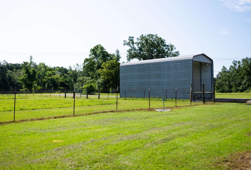 Metal utility structure with an arched roof and open-ended design
