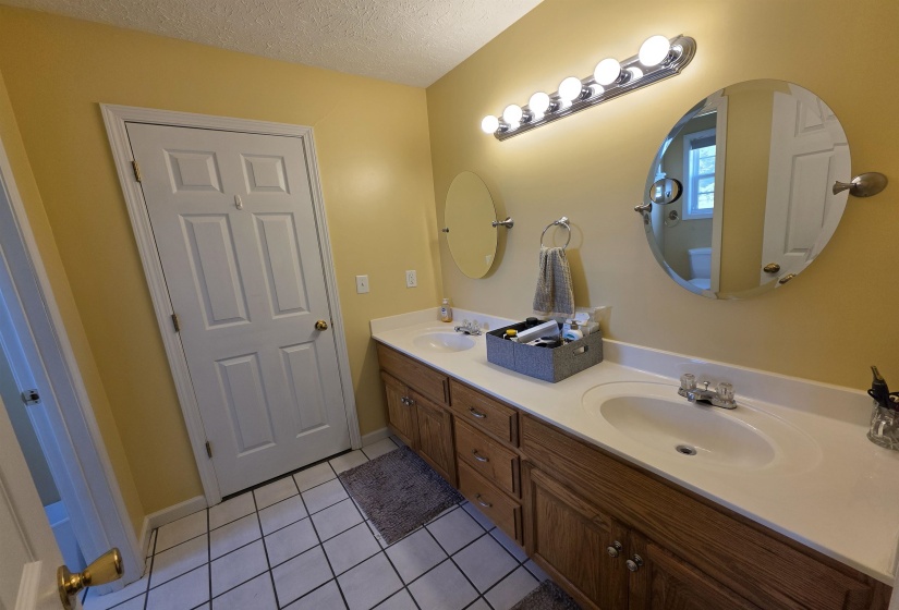 Dual vanity with wood-finish cabinetry and integrated white sinks