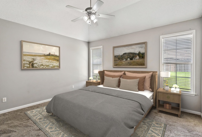 Carpeted bedroom featuring neutral wall tones and a vaulted ceiling