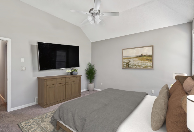 Vaulted ceiling with a white ceiling fan