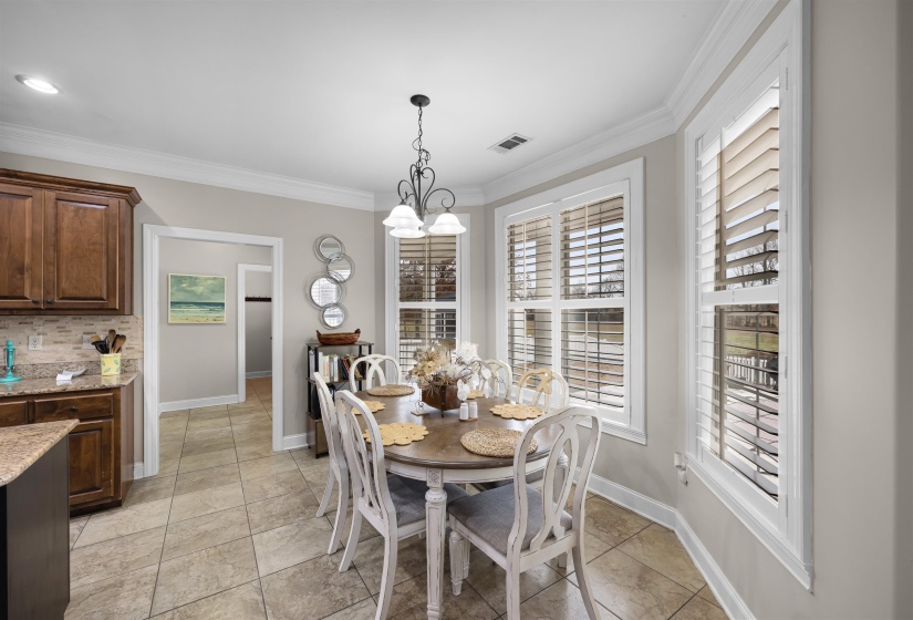 Dining space with a chandelier and ornamental molding