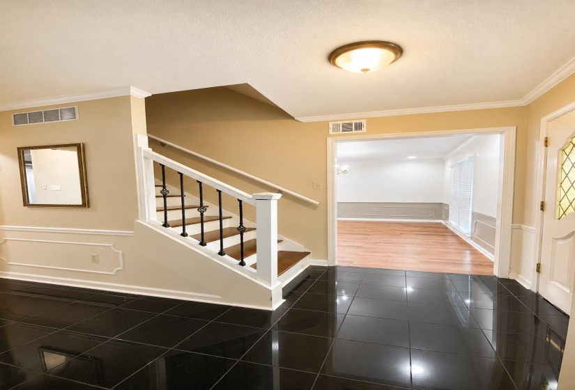 Entry foyer featuring polished black tile flooring