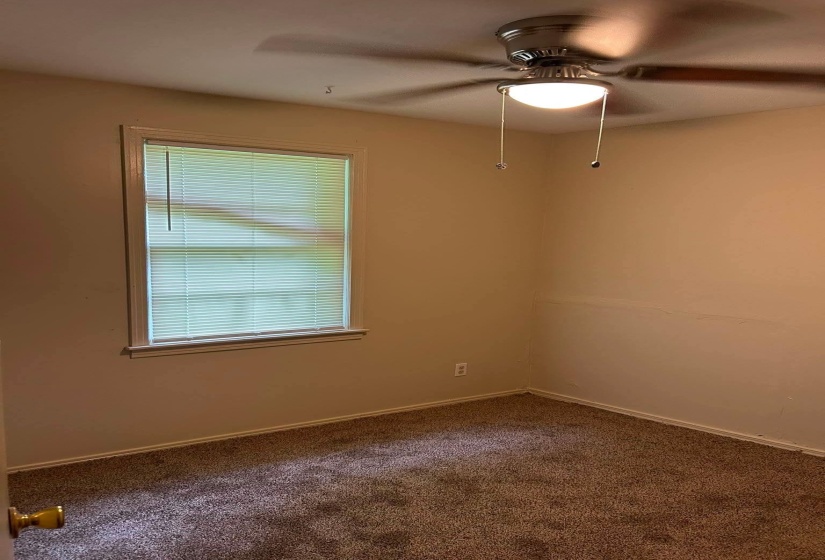 Neutral-toned walls complement the brown carpeted flooring