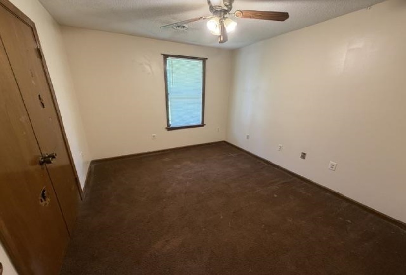 Room featuring brown carpet flooring, light-colored walls, and a window with blinds
