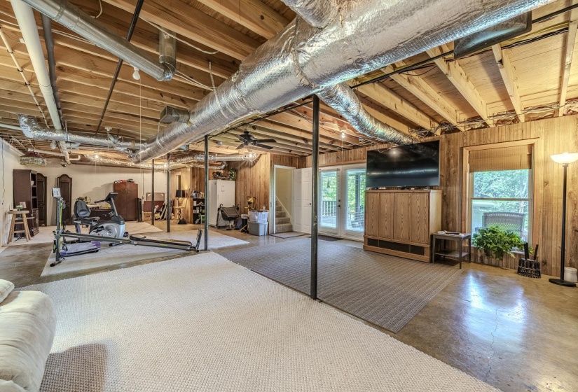 Expansive lower-level space featuring exposed wood joists and ductwork